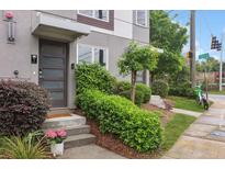 Modern townhome featuring manicured landscaping and a contemporary front door with frosted glass panes at 1672 Dekalb Ne Ave # 2, Atlanta, GA 30307