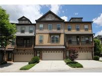 Charming townhomes featuring a modern exterior with multi-car garages and brick accents at 3220 Creole Ln, Avondale Estates, GA 30002