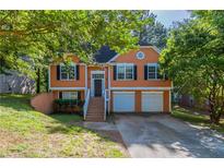 Charming two-story home with attached two-car garage and inviting front porch at 7074 Springgrove Ct, Austell, GA 30168