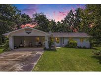 Charming single-story home with a lovely front yard and attached carport, perfect for suburban living at 105 Tranquility Dr, Villa Rica, GA 30180
