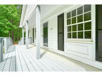 Inviting front porch features painted deck, white columns, and black shutters, creating a charming curb appeal at 175 Smith Ferguson Rd, Dallas, GA 30157