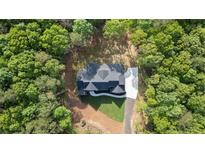 A beautiful new construction home is nestled in a private, wooded lot with long driveway and fresh sod at 5567 Tyree Rd, Winston, GA 30187