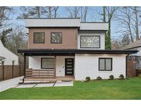 Two-story home featuring a modern design with a well-manicured lawn and complementary landscaping at 1355 Lockwood Sw Dr, Atlanta, GA 30311