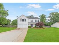 Charming two-story home with a well-manicured lawn, two-car garage, and inviting curb appeal at 1194 Grandview Cir, Powder Springs, GA 30127