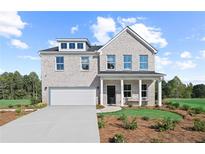 Beautiful two-story home with a light brick exterior, attached garage, and manicured front lawn at 1640 Tide Mill Rd, Cumming, GA 30040