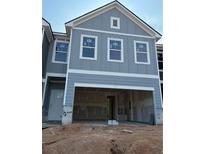 New construction home featuring a two-car garage and classic exterior details at 218 Seward St # 92, Conyers, GA 30094