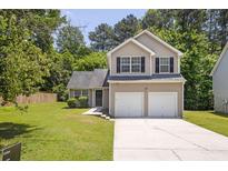 Charming two-story home with a well-maintained lawn and a two-car garage at 3534 Oakshire Se Way, Atlanta, GA 30354