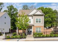 Charming two-story home boasts a brick facade, neutral siding, and a well-manicured front yard with a decorative fence at 2792 Mathews Se St, Smyrna, GA 30080