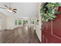 Inviting living room with hardwood floors, ceiling fan, and sliding glass doors to outdoor space at 909 Wentworth Ct, Alpharetta, GA 30022