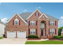 Charming two-story brick home with a well-manicured lawn, a two car garage and inviting front entrance at 2372 Wilshire Way, Douglasville, GA 30135