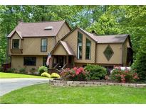 Inviting two-story home featuring a unique design, colorful landscaping, and charming front entrance at 2694 Tritt Springs Ne Dr, Marietta, GA 30062