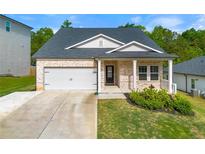 Charming single-Gathering home featuring a well-manicured lawn, attached garage, and inviting entryway at 423 Murphy Ave, Canton, GA 30114