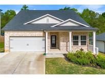 Charming single-Gathering home with brick facade, attached garage, and manicured lawn in a well-kept neighborhood at 423 Murphy Ave, Canton, GA 30114