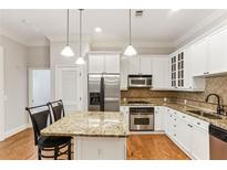 Beautiful kitchen with granite countertops, stainless steel appliances, and white cabinetry at 11 Perimeter E Ctr # 1402, Dunwoody, GA 30346