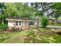 Charming single story home with manicured front lawn and mature trees at 50 Woodland St, Buford, GA 30518