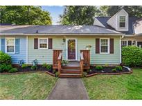 Charming home with a well-maintained lawn, flower beds, and inviting front porch entrance at 812 Manning Sw Way, Marietta, GA 30064