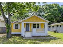 Charming bungalow featuring a cozy front porch and a cheerful yellow and white exterior at 103 Chicamauga Sw Ave, Atlanta, GA 30314