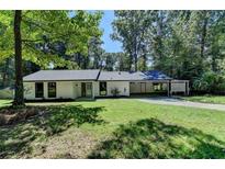 Charming single-story home with a well-manicured lawn and convenient carport at 1192 Sandalwood Dr, Lawrenceville, GA 30043