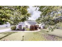 Charming single-story home with well-manicured lawn and mature trees at 150 Mills Creek Ln, Covington, GA 30016