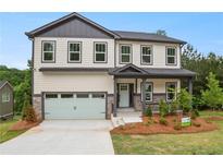 Two-story home featuring neutral siding, dark trim, inviting front porch and a two car garage at 2732 Eagles Crest Ln, Decatur, GA 30034