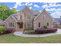 Charming two-story brick home with manicured landscaping and a welcoming entrance at 980 Pine Grove Rd, Roswell, GA 30075