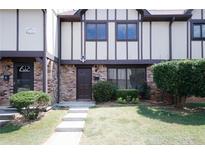 Charming townhome featuring brick and siding, complemented by a well-manicured lawn at 1199 Ashborough Se Dr # K, Marietta, GA 30067