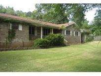 Traditional brick ranch with a well-maintained lawn at 6290 S Skyline Dr, Douglasville, GA 30135