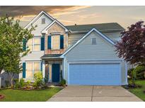 Charming two-story home featuring a well-manicured lawn and a two-car garage with blue shutters at 789 Clairidge Elm Sw Trl, Lawrenceville, GA 30046