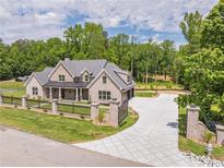Stunning brick home with meticulously maintained lawn, black iron fence, and patterned concrete driveway at 140 Maranatha Trl, Lawrenceville, GA 30045