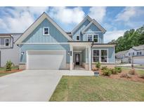 Charming two-story home with light blue siding, white trim, and a well-manicured lawn at 212 Birchwood Row, Canton, GA 30115