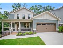 Charming home with a welcoming front porch, a well-manicured lawn, and a two-car garage at 2714 Eagles Crest Ln, Decatur, GA 30034