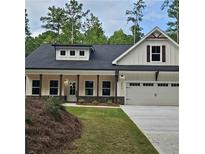 Charming new construction home featuring a landscaped front yard and a two-car attached garage at 6093 Wayarer Dr, Villa Rica, GA 30180