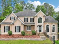 Stunning two-story home with a manicured front yard and elegant architectural details at 503 Kensington Estates Trce, Woodstock, GA 30188