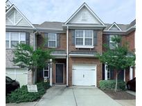 Charming brick townhome with a one car garage and well maintained front yard at 5620 Moresby Ct, Alpharetta, GA 30022