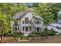 Two-story home with a stone entryway, large windows, and professionally landscaped front yard at 2655 Boulder Creek Ne Dr, Roswell, GA 30075