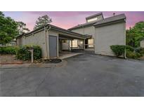 Charming home featuring a carport, mature trees, and a well-maintained yard at sunset at 683 Highland Ct, Marietta, GA 30068