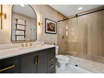 Modern bathroom features an elegant vanity with stone countertop and a glass-enclosed shower at 860 Peachtree Ne St # 1513, Atlanta, GA 30308