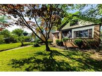 A charming brick home with mature trees and a well-manicured front lawn at 1029 Katherwood Sw Dr, Atlanta, GA 30310