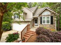 Charming two-story home with stone accents, a well-manicured yard, and a cozy front porch at 3573 Bramwell Nw Xing, Kennesaw, GA 30144