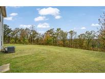Expansive back yard with lush green grass and mature trees providing privacy at 3530 Ridge Hill Pkwy, Douglasville, GA 30135