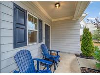 Inviting front porch featuring two blue Adirondack chairs and dark blue shutters at 3530 Ridge Hill Pkwy, Douglasville, GA 30135