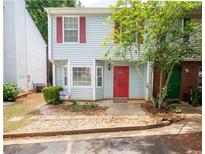 Charming townhome with light blue siding, red shutters, and a well-maintained front yard for sale at 6366 Jasper Ct, Tucker, GA 30084