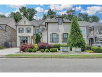 Beautiful two-story home featuring a brick exterior, manicured lawn, and tasteful landscaping at 1839 Kent Ave, Atlanta, GA 30338