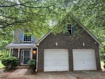 Charming two-story home features a brick facade and a two-car garage at 3953 Cress Way Run, Decatur, GA 30034