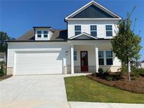 Charming two-story home with a white exterior, black shutters, and a well-manicured lawn, offering classic curb appeal at 803 Levi Farms Ln, Canton, GA 30115