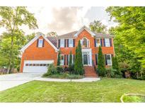 Beautiful two story brick home featuring a manicured lawn and an attached two-car garage at 2641 Loch Way, Snellville, GA 30039