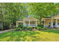 Charming bungalow with a welcoming front porch, mature trees, and lush landscaping at 1443 Metropolitan Se Ave, Atlanta, GA 30316