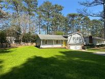 Charming home with a manicured lawn and inviting yellow front door at 3210 Ebenezer Rd, Marietta, GA 30066