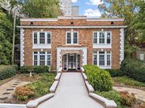 Charming brick building with beautifully landscaped front yard and inviting entrance at 242 12Th Ne St # 14, Atlanta, GA 30309