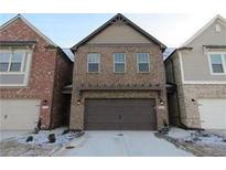 Beautiful two-story brick home with a two-car garage and a well-maintained yard at 8265 Village Pl, Suwanee, GA 30024